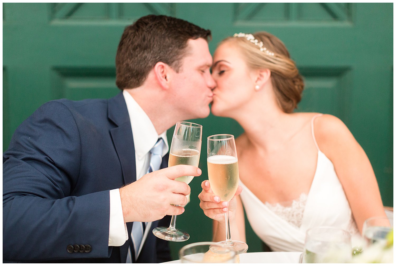 Bride and groom cheers with kiss