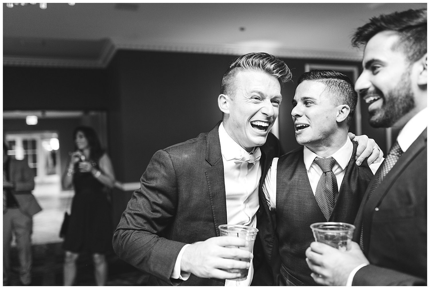 Groom laughing black and white