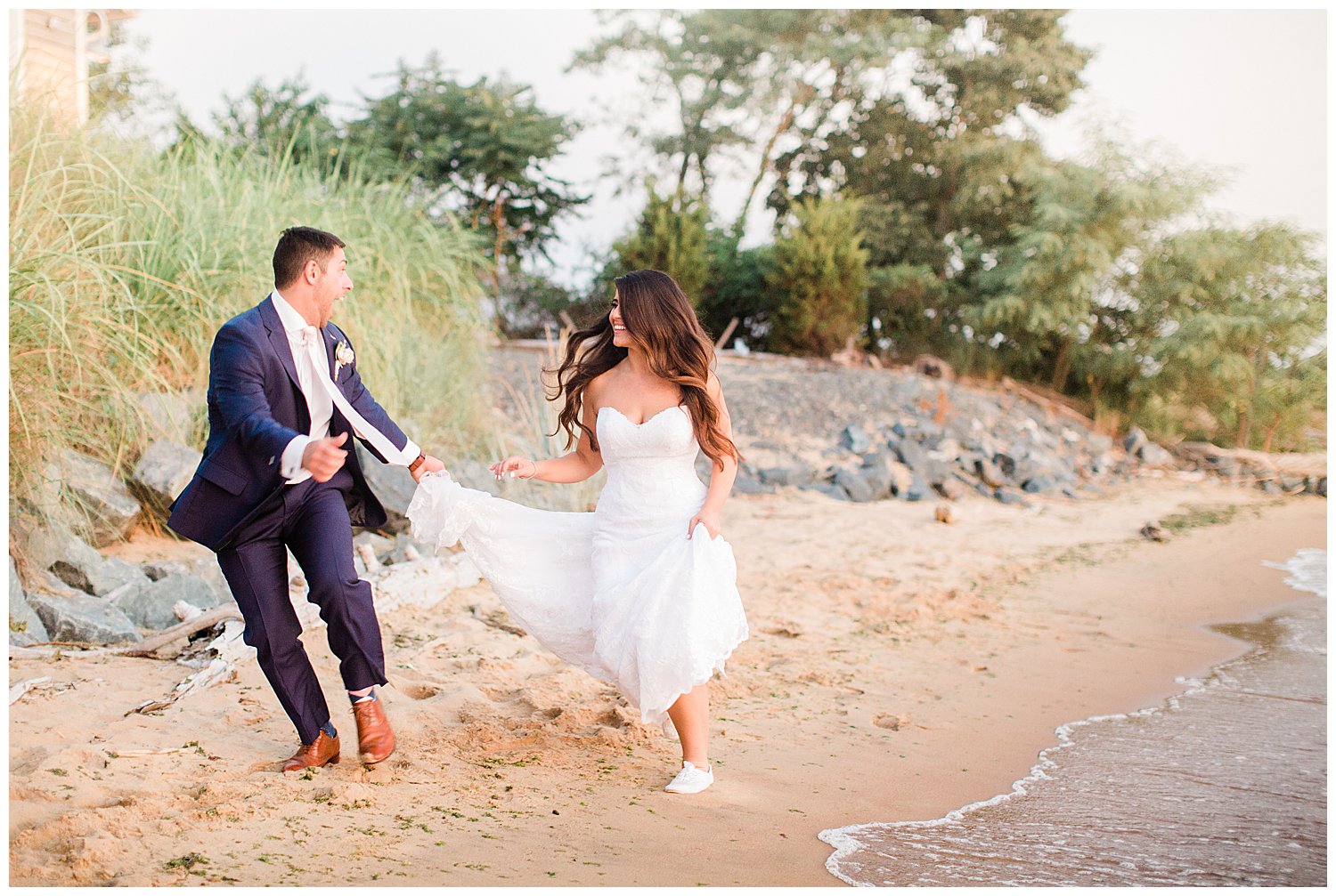Bride and groom running on beach